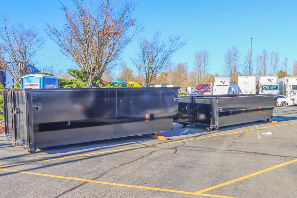 Professional dumpster rental service with roll-off container on residential driveway in Jerome